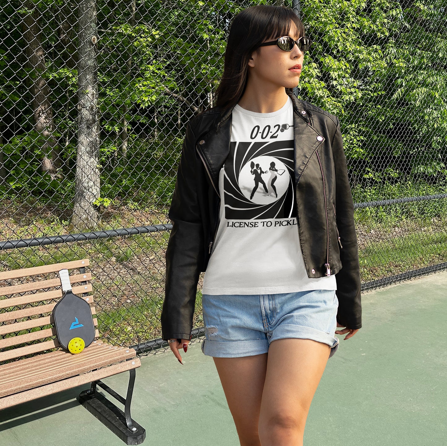 Woman on pickleball court wearing 0-0-2 License To Pickle white t-shirt