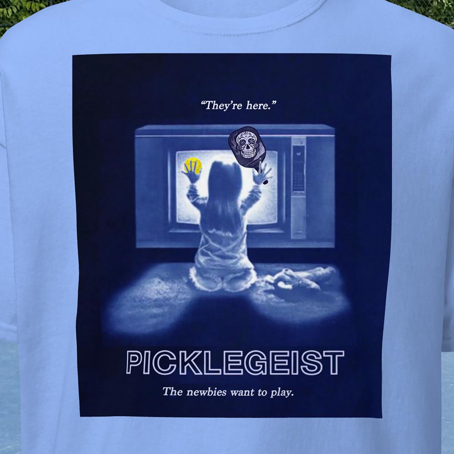 Closeup view of Picklegeist graphic on front of Men's Carolina Blue pickleball shirt