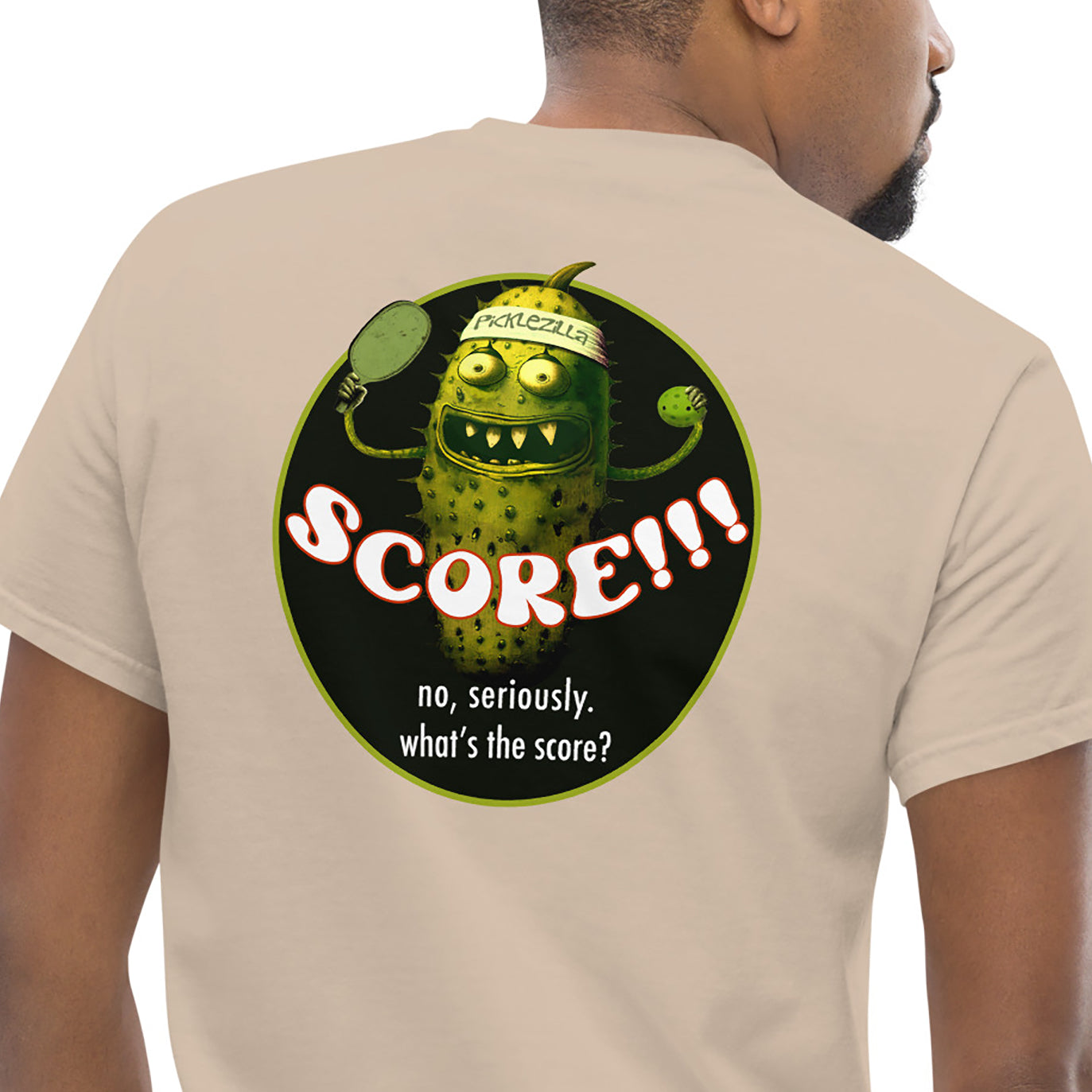 Closeup view of Picklezilla Score graphic on back of mens pickleball t-shirt, sand colored